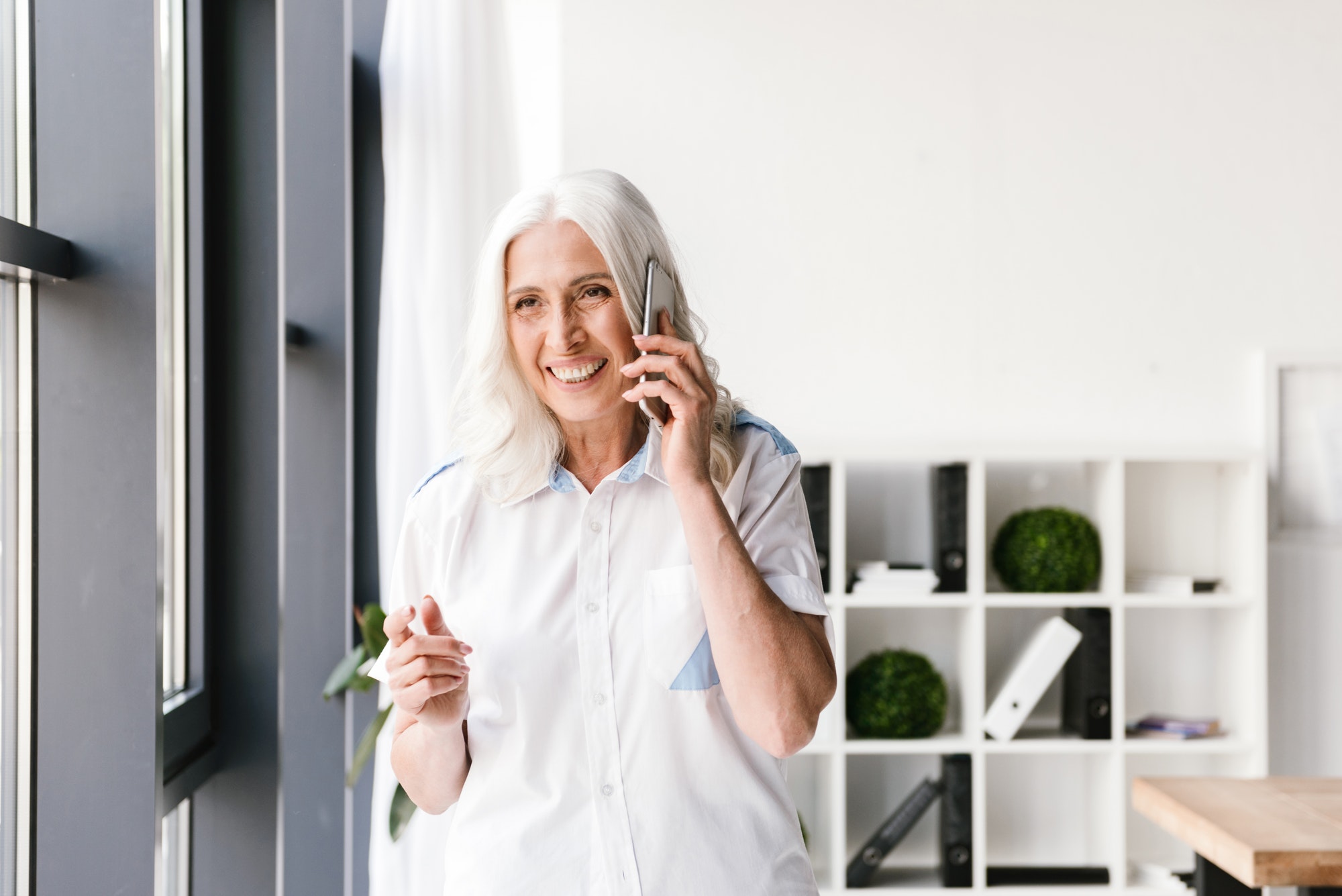 Mature happy woman indoors in office