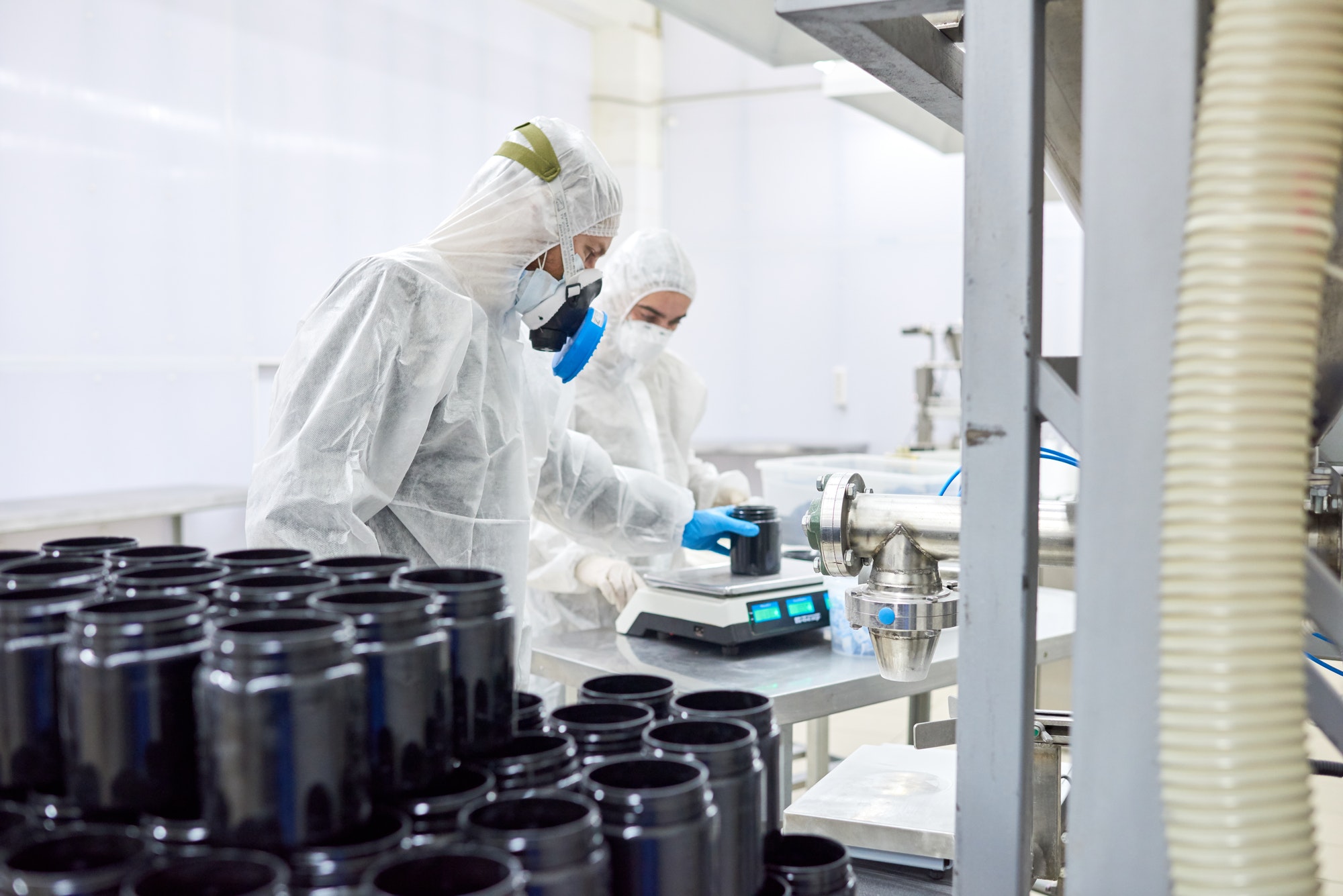 Pharmaceutical Plant Workers Using Scale