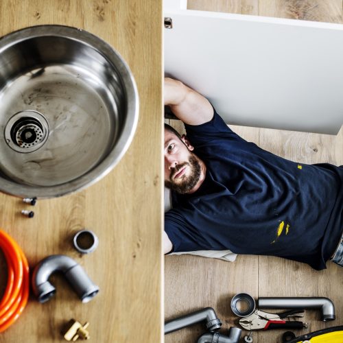 man-fixing-kitchen-sink